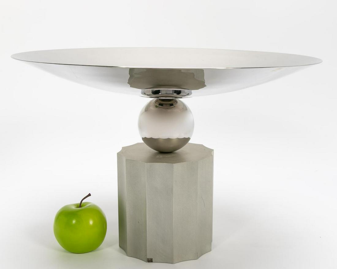 BREUTON LARGE POLISHED STAINLESS "EMPIRE" BOWL: Stanley Jay Friedman for Brueton Furniture (American, founded 1926), early 21st century. An "Empire" large polished tapered stainless steel bowl, having a spherical stem and resting on an acid washed
