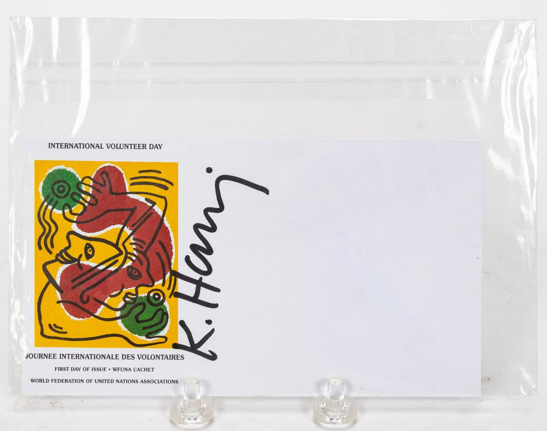 KEITH HARING INTERNATIONAL VOLUNTEER DAY ENVELOPE: Keith Haring (American, 1958-1990). "International Volunteer Day" - 1988, unstamped envelope issued by the United Nations with Keith Haring artwork, signed in black marker "K. Haring". Approx: 3.5" x 