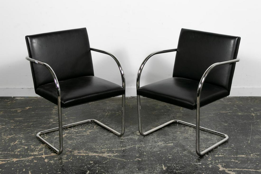 PAIR, BREUTON "TUBULAR" CANTILEVER CHAIRS: Brueton Furniture (American, founded 1926), early 21st century. Pair of "Tubular" cantilever chairs having a 14 gauge, 1" stainless steel frame with curved arms and black leather back and seat. Marked