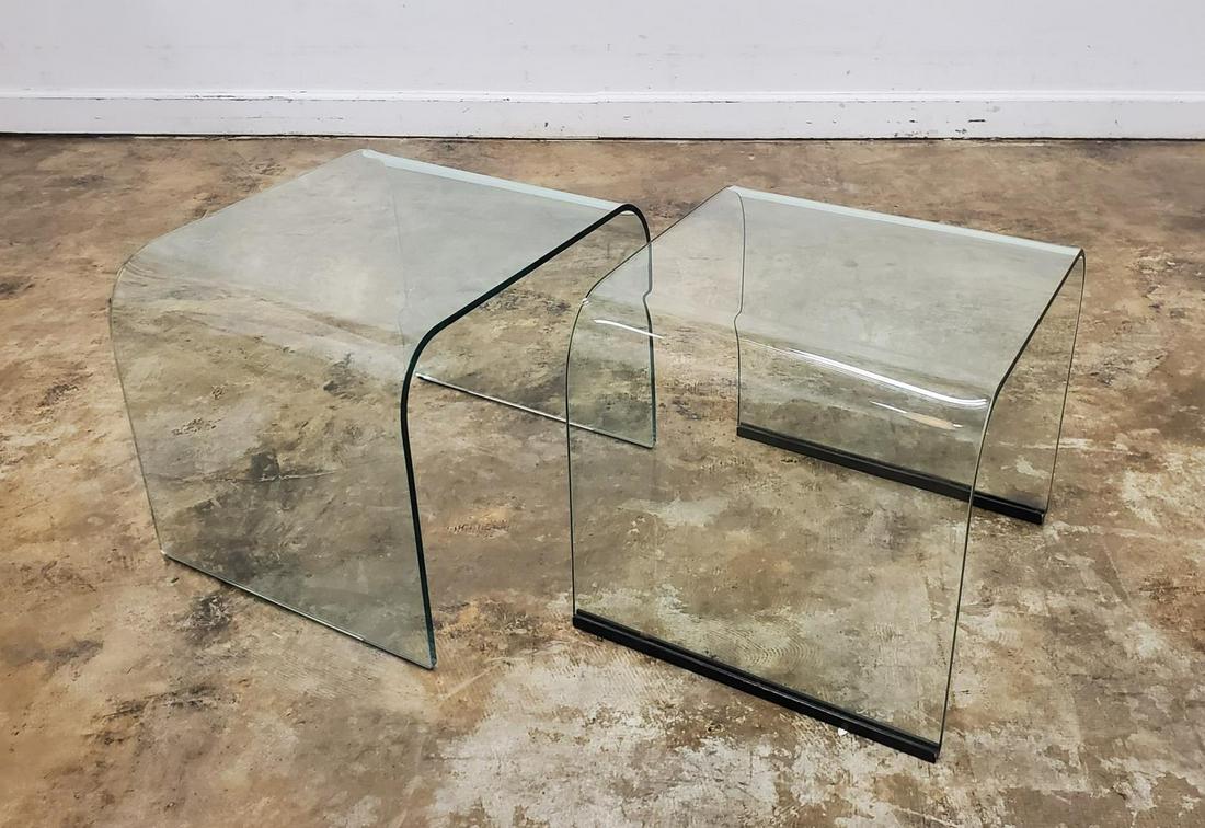 SET OF TWO PACE COLLECTION GLASS NESTING TABLES: Leon Rosen for The Pace Collection (American, 1960-2001), circa 1990. Set of two curved waterfall form colorless glass nesting tables. Apparently unmarked. Approx. of the largest h. 17.25”, w. 20.25