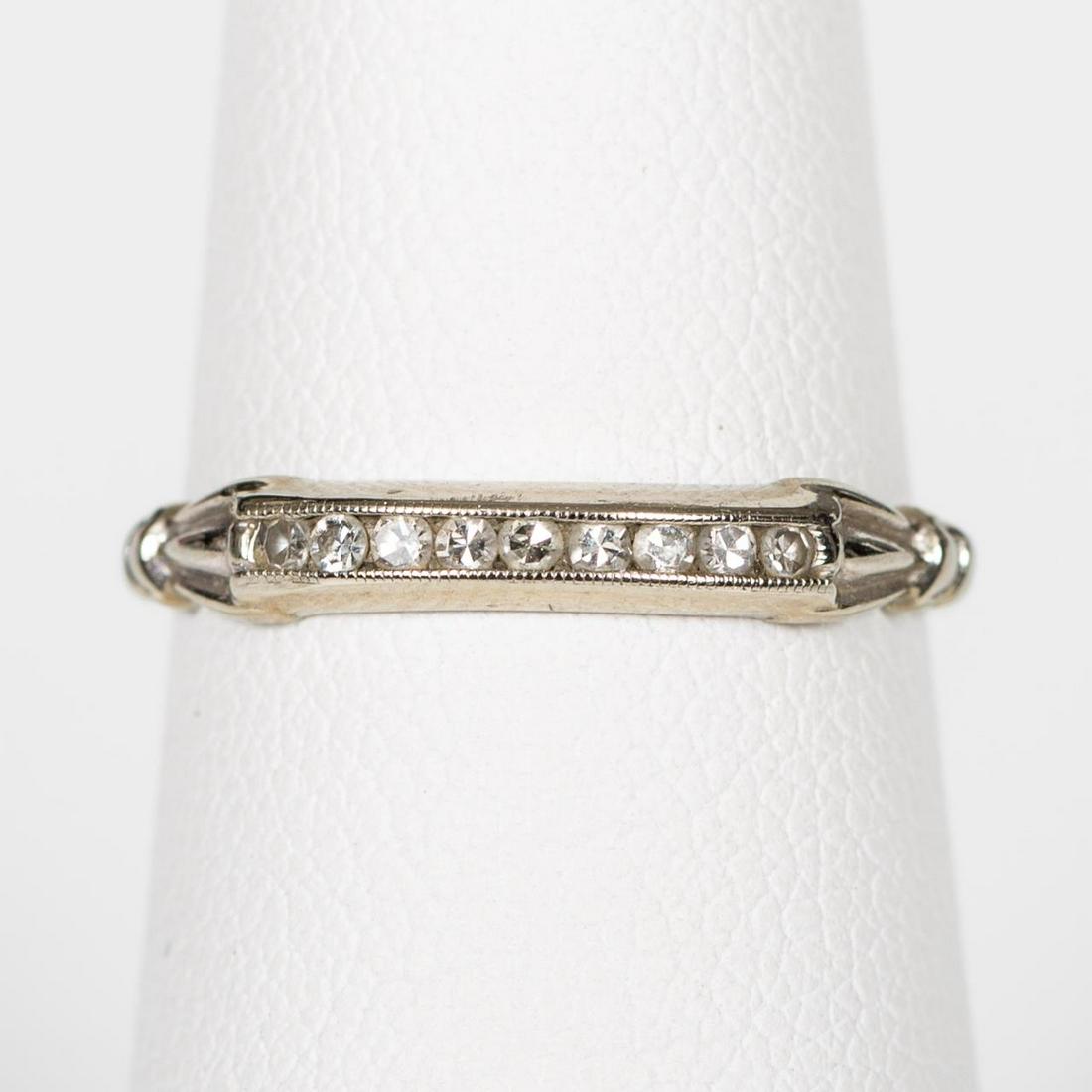 18K WHITE GOLD & DIAMOND WEDDING BAND, 1940'S: A 1940's 18k white gold filigree and diamond wedding band with nine single cut natural diamonds (approx. 0.09 ctw, color range: H-I, clarity: VS2). Marked for 18k gold quality. US ring size approx. 5.
