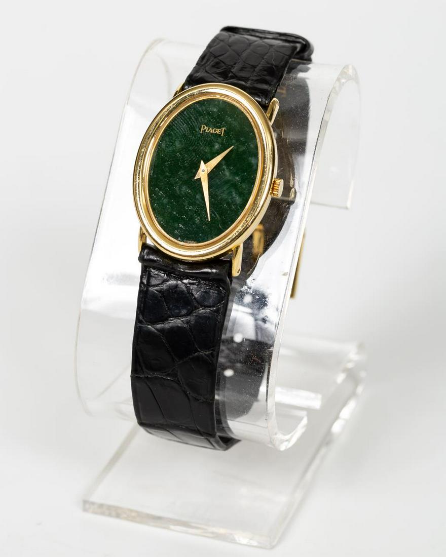 PIAGET 18K YELLOW GOLD OVAL FORM WATCH, 9862: A vintage Piaget (Swiss, founded 1874) 18k yellow gold watch with oval face, green marble dial and leather band. Marked to back 9862, 214397. Approx. 8.5 leather wrist band. Approx. total weight 31.4g
