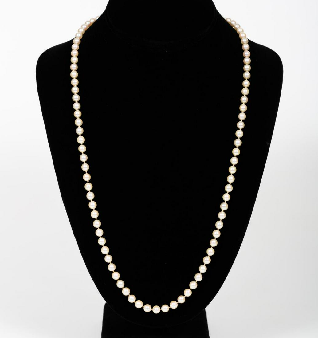MIKIMOTO, STERLING SILVER & AKOYA PEARL NECKLACE: Mikimoto Pearls (Japanese, founded 1893), 20th century. A strand of ninety-three akoya pearls (6.12mm) set with a sterling silver clasp and single set akoya pearl. Marked to clasp with Mikimoto “M��