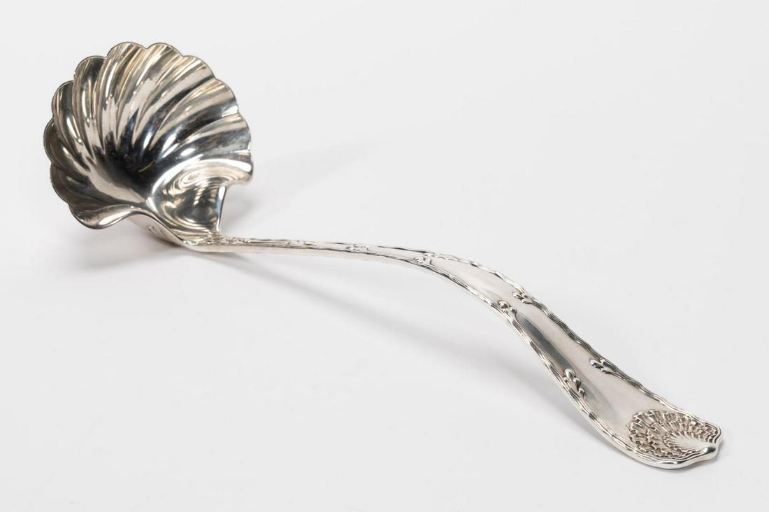 TIFFANY & CO. "WAVE EDGE" STERLING PUNCH LADLE: Tiffany & Company (American, founded 1837), circa 1884. A sterling silver punch ladle with shell bowl in "Wave Edge" pattern. Marked to back with makers mark, sterling and pat. 1884. Approx. l. 12.75"