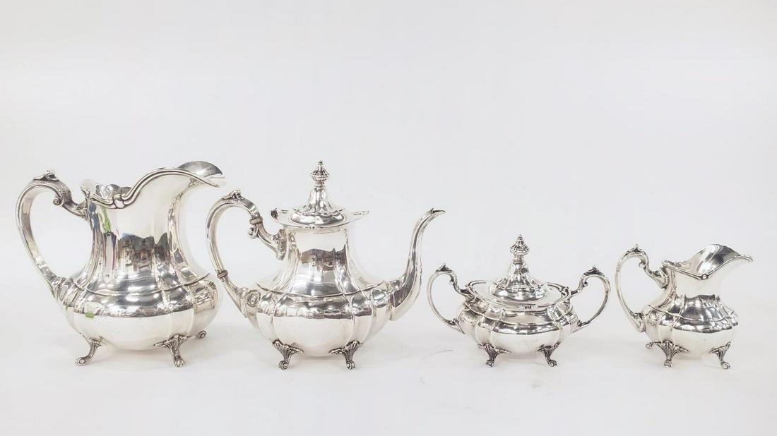 4 PIECE, FISHER "FOOTED DUNCAN" STERLING TEA SET: Fisher Silversmiths (American, founded 1936), circa 1960. A four piece sterling silver tea set including a water pitcher (9"), a teapot (9.5"), a covered sugar (6") and a creamer (6"). Each marked to