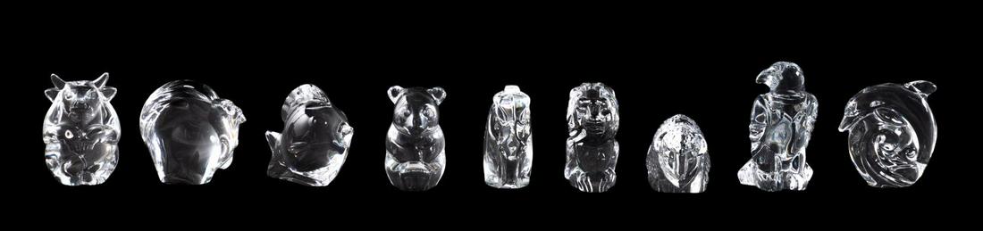 NINE, STEUBEN WORKS GLASS ANIMAL HAND COOLERS: Steuben Glass Works (American, founded 1903), contemporary. Group of nine colorless crystal hand coolers or paperweights comprising an American eagle", bull, bear, dolphin, fish, sitting lion, horse's