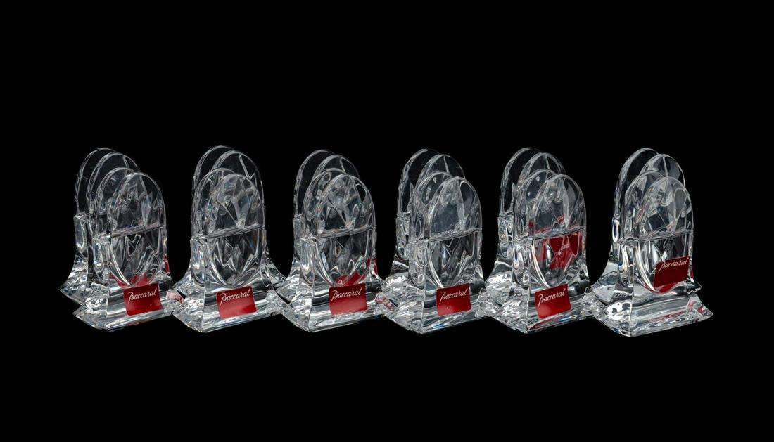 SET, 12 BACCARAT "TRANQUILITY" PLACE CARD HOLDERS: Baccarat, contemporary. Set of twelve colorless crystal "Tranquility" (introduced 2000, inactive) oval form place card holders having a diamond pattern. Acid marked to the underside with ten retaining