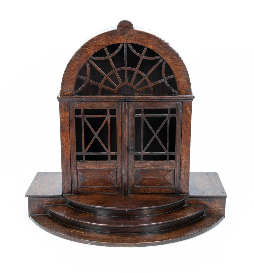19TH C. ENGLISH ARCHITECTURAL MODEL OF A DOORWAY: English, 19th century. A carved oak architectural model or maitrise of a doorway with three steps, carved door window panels and an arched upper window. Apparently unmarked. Provenance: Acquired from