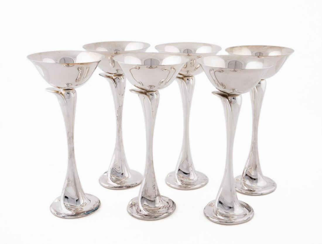 SET, SIX ELSA PERETTI STERLING CHAMPAGNE COUPES: Elsa Peretti for Tiffany & Co., contemporary. Set of six sterling silver floral form champagne coupes having a flared bowl and elongated stem, rising on an oval foot. Marked to the underside. Approx. 
