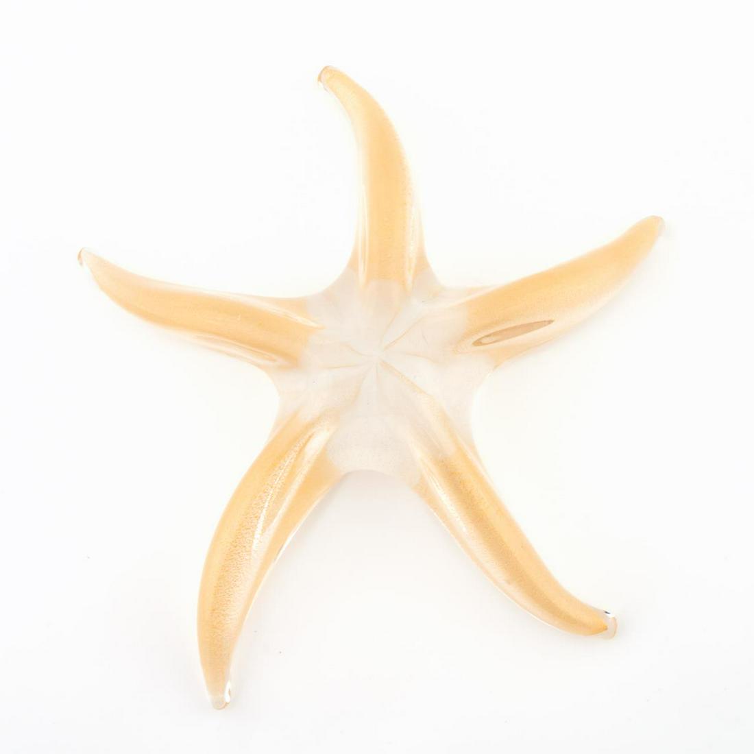 ELSA PERETTI HANDBLOWN GLASS STARFISH FIGURE: Elsa Peretti for Tiffany & Co., contemporary. A decorative handblow Murano glass starfish in colorless and gold flecked glass. Etched signature and maker's mark to underside. Approx. w. 9.25".