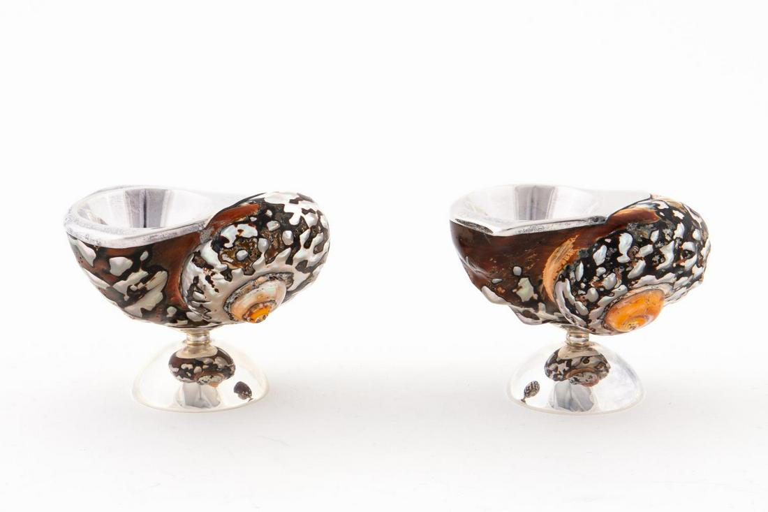 PR., STERLING MOUNTED TURBAN SHELL SALT CELLARS: Possibly Italian, contemporary. Pair of salt cellars having natural polished turban shells and sterling silver mounts and domed feet. Marked "CM/Sterling/925". Approx. of one, h. 2.75", w. 3.25", d. 2