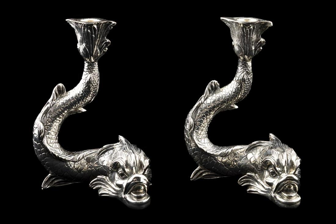 PAIR, CAMUSSO DOLPHIN STERLING SILVER CANDLESTICKS: Camusso (Peruvian, founded 1933), 20th century. Pair of well formed sterling silver single light dolphin form candlesticks. Marked to the underside. Approx. of one, h. 7.5", w. 4.25", d. 4"; total app