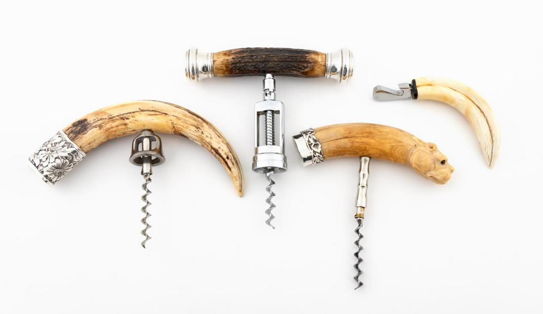 FOUR HORN & ANTLER BARWARE PIECES: American / English, 20th century. Group of four piece antler and horn barware comprising of one polished horn corkscrew with floral sterling silver cap, one carved dog head corkscrew with sterling sil