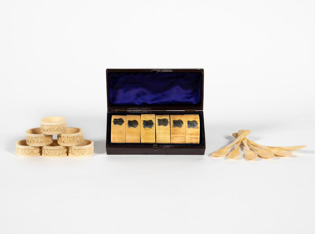GROUP OF 18 CARVED BONE TABLE ACCESSORIES: Early to late 20th century. A grouping of eighteen carved bone table accessories including a set of six English cased sterling silver mounted napkin rings marked "HF", six carved Chinese floral bone n