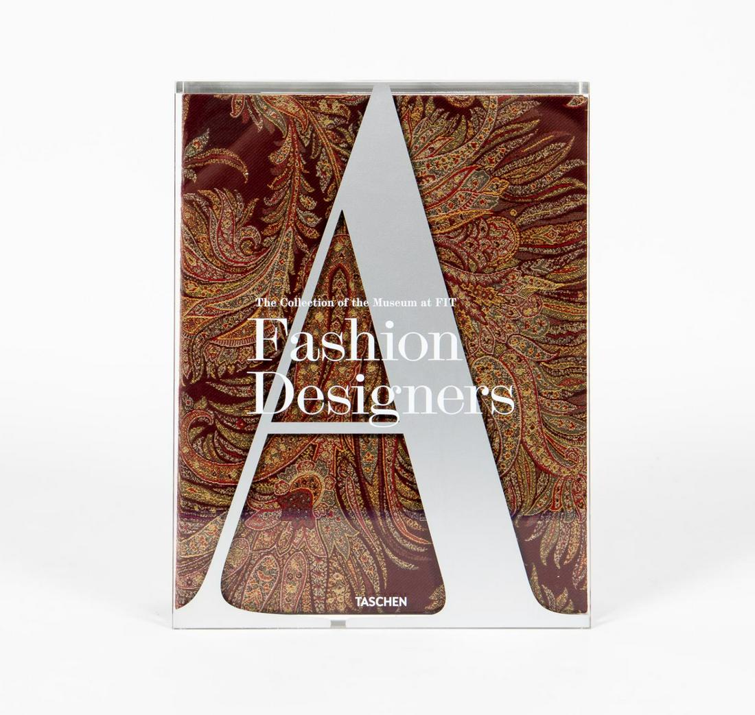 COLLECTION OF THE MUSEUM AT FIT: ETRO EDITION BOOK: An oversized hardcover coffee table book fitted in an acrylic case on the famous fashion in the collection of the museum at FIT featuring over 500 pieces in the permanent collection with full color il