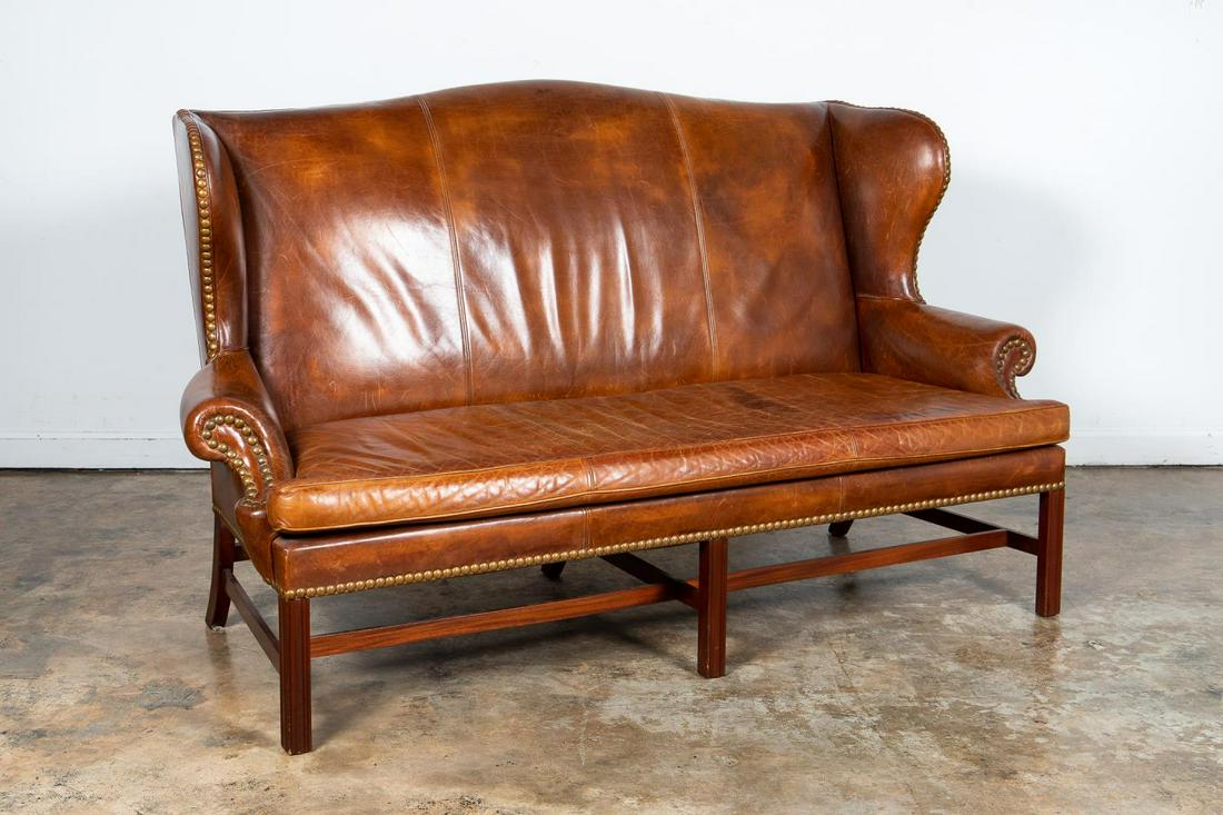 RALPH LAUREN WINGBACK STYLE LEATHER SOFA: Ralph Lauren Home, contemporary. Leather wingback sofa in the Georgian taste having caramel hued upholstery, nailhead trim, loose seat cushion and rising on front fluted square legs. Unamarked. Proven