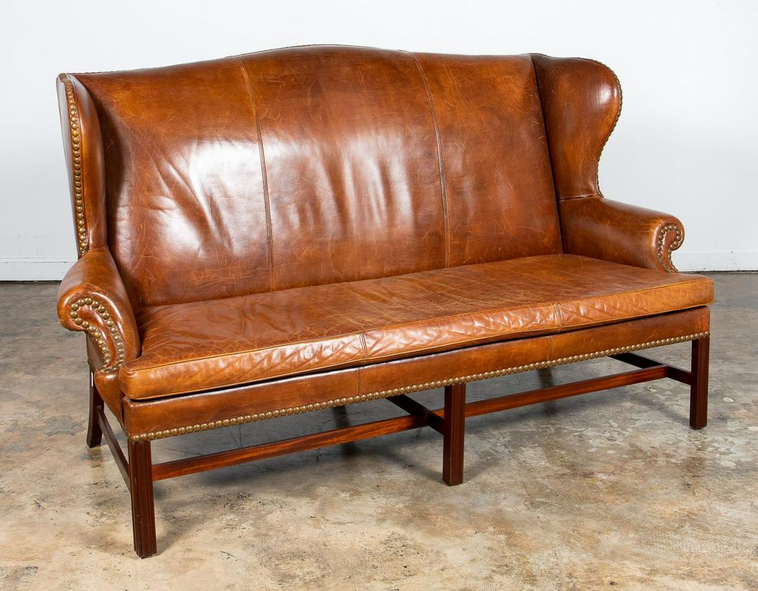 RALPH LAUREN WINGBACK STYLE LEATHER SOFA: Ralph Lauren Home, contemporary. Leather wingback sofa in the Georgian taste having caramel hued upholstery, nailhead trim, loose seat cushion and rising on front fluted square legs. Unamarked. Proven