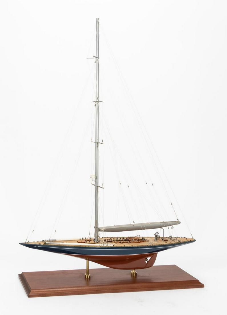 CONTEMPORARY POLYCHROMED WOODEN SAILBOAT MODEL: Contemporary. A sailboat model with red and blue painted hull, highly detailed deck construction and tethered rope sail construction. Apparently unmarked. Approx: h. 36", w. 6", d. 25".