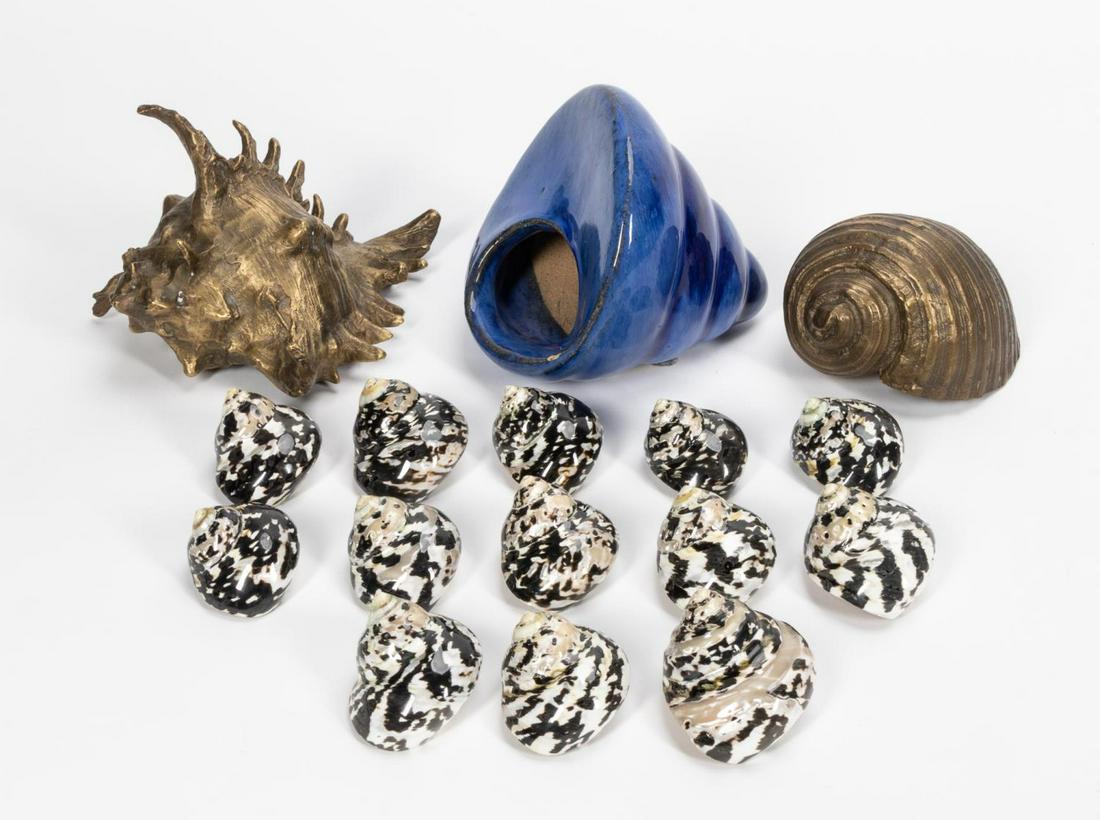 16 DECORATIVE SEASHELL & SEASHELL OBJECTS: 20th century. A grouping of sixteen seashell and shell objects including thirteen Cittarium Pica shells, two brass conch shells and a blue glazed pottery conch. Approx: h. 5.75", w. 5.25", d. 6" (Larg