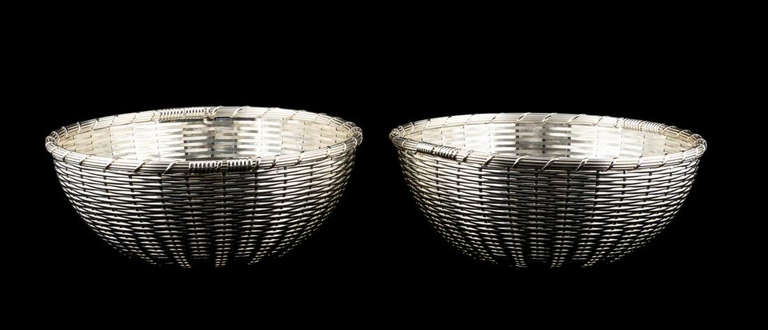 PAIR, CHRISTOFLE WOVEN SILVER PLATE BREAD BASKETS: Christofle, contemporary. Pair of woven silver plate circular bread baskets. Marked to the underside. Provenance: Acquired from Christofle, 2005 Approx. of one, h. 3.25", dia. 8.75".