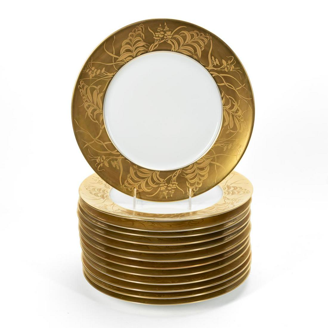 SET, 13 JEAN LOUIS COQUET LIMOGES SERVICE PLATES: French, pattern active 1994-2014. A set of thirteen "Khazard Gold" pattern service plates with gold encrusted ferns and grasses to bordering. Marked to underside for Limoges, Jean Louis Coquet. Approx