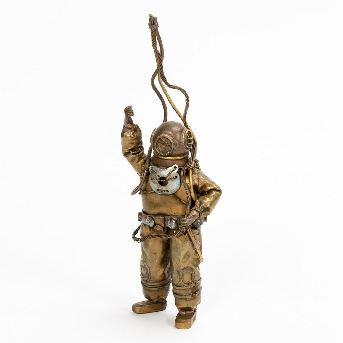 CHILEAN MID CENTURY "SCUBA MAN" FIGURAL SCULPTURE: Chilean, mid century. A well formed mixed metal sculpture of a scuba diver with helmet, dive rope, suit and air tanks. Marked to feet "Chile" and bearing dealer stickers to verso priced at $1400. Appr