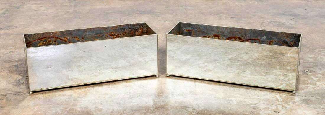 PAIR, RECTANGULAR ANTIQUED MIRRORED PLANTER BOXES: Pair of rectangular table top planter boxes, metal framed with antiqued mirror panel sides and base, polished metal interior, on ball feet. Apparently unmarked. Approx. h. 9.25", w. 25.5", d. 9.5"
