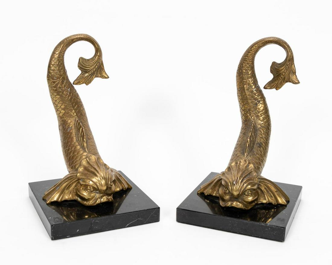 PAIR, BRASS CHINESE DOLPHIN FORM BOOKENDS: Likely Italian, second half 20th century. Pair cast brass Chinese dolphin form bookends with turned tails, on black marble bases. Unmarked. Approx. of one, h. 10.25", w. 6.25", d. 6.75"