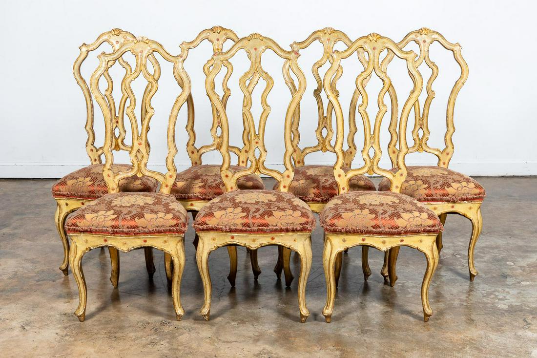 7 ITALIAN ROCOCO POLYCHROME & GILT SIDE CHAIRS: Italian, 20th century. Set of seven polychrome and parcel-gilt side chairs having shell carved crests, shaped backs, pierced splats, floral decoration and upholstery and rising on front cabriole legs.
