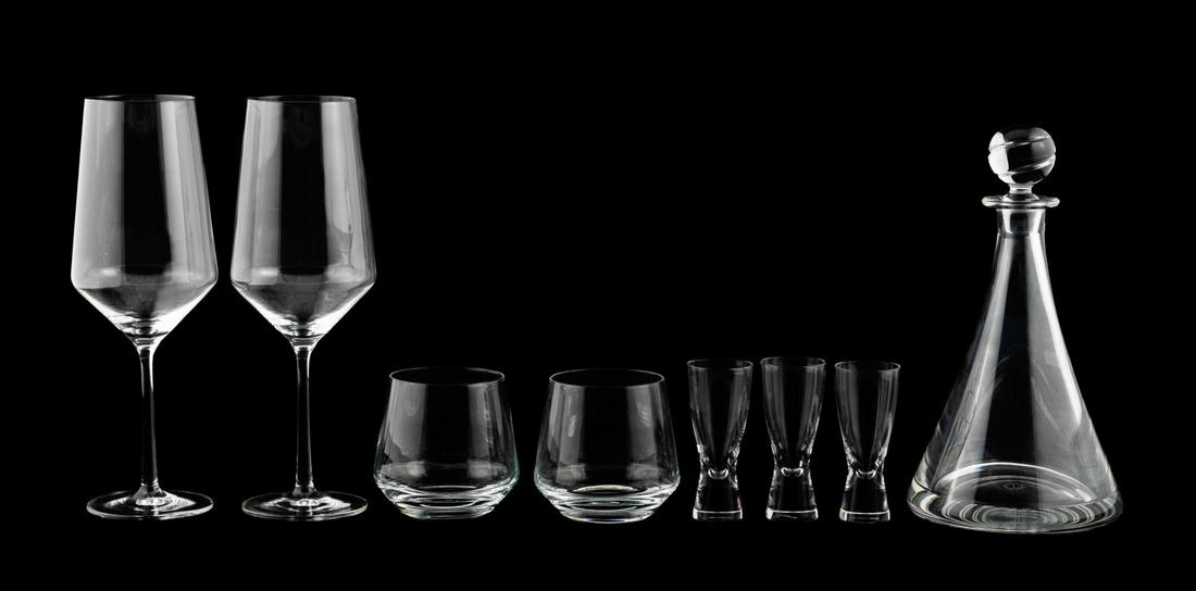 8 PC MODERN COLORLESS GLASS BARWARE, INCL. STEUBEN: American, French, & German, 20th century. Group of modern colorless glass barware comprising of one St. Louis beaker shaped decanter, three Steuben shot glasses, two Schott-Zwiesel "Pure" bordeaux win