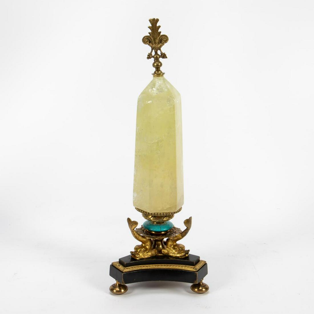 ATELIER DUPONT ROCK CRYSTAL AND TURQUOISE OBELISK: Atelier Klaus Dupont, late 20th to early 21st century. Neoclassical style yellow rock crystal obelisk surmounted by a foliate finial with a flattened turquoise disc below, on a gilt bronze and black b