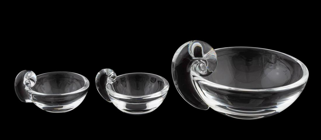 THREE, STEUBEN CRYSTAL OLIVE DISHES, SNAIL HANDLE: Steuben Glass Works, design introduced 1939, contemporary. Group of three scroll or snail handle dishes comprising of one olive dish, and two small sauce dishes. All three etched to underside "Steuben