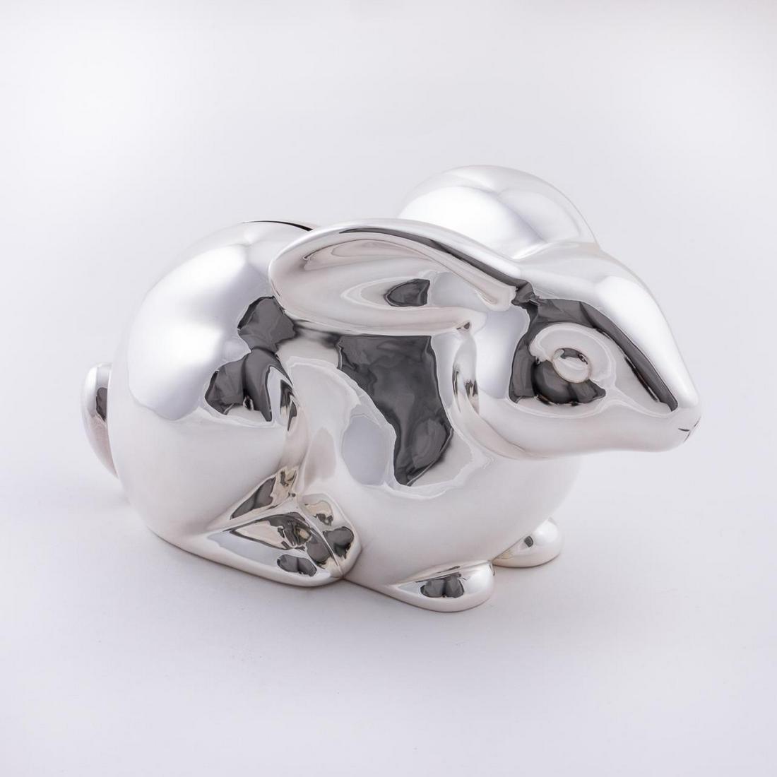 TIFFANY & CO. STERLING RABBIT FORM COIN BANK: Tiffany & Co., 2003. American sterling silver rabbit / bunny form coin or piggy bank. Maker's mark, date, ".925", and "Italy" to underside. Accompanied by dust bag. Approx. total weight 12.96 ozt. App
