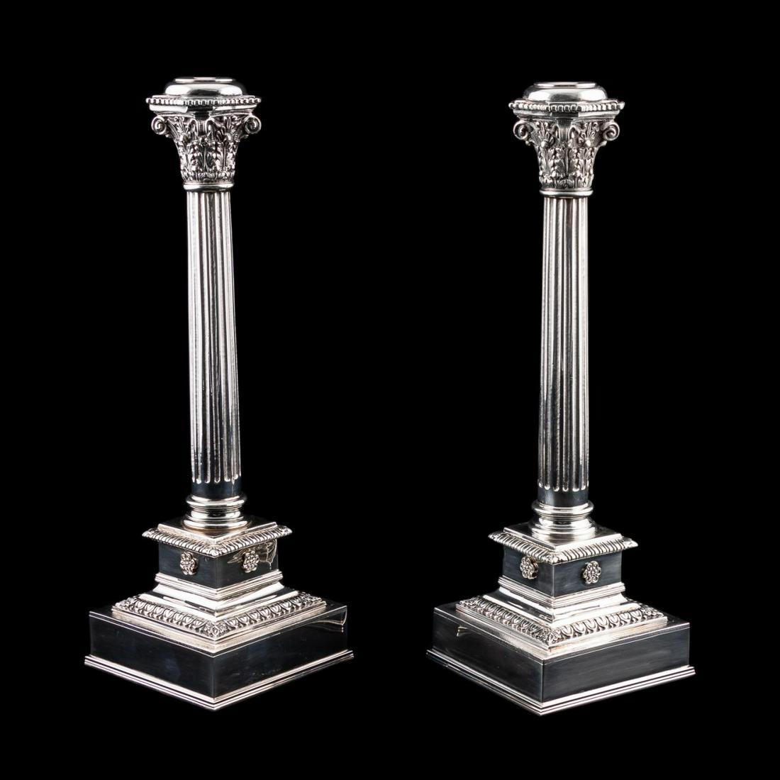 PR., BUCCELLATI STERLING COLUMN FORM CANDLESTICKS: Buccellati (Italian, founded 1919), late 20th century. Pair of sterling silver Corinthian column form candlesticks, in the neoclassical taste, having a fluted shaft, plinth with rosette medallions, an