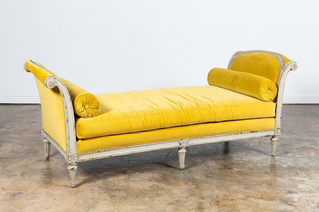 DISTRESSED LOUIS XVI STYLE GOLD VELVET SETTEE: Likely French, 20th century. Louis XVI style daybed with gold silk velvet upholstery and distressed wood finish. Accompanied by two bolsters. Apparently unmarked. Approx. h. 33.75", w. 84.25", d. 31.3