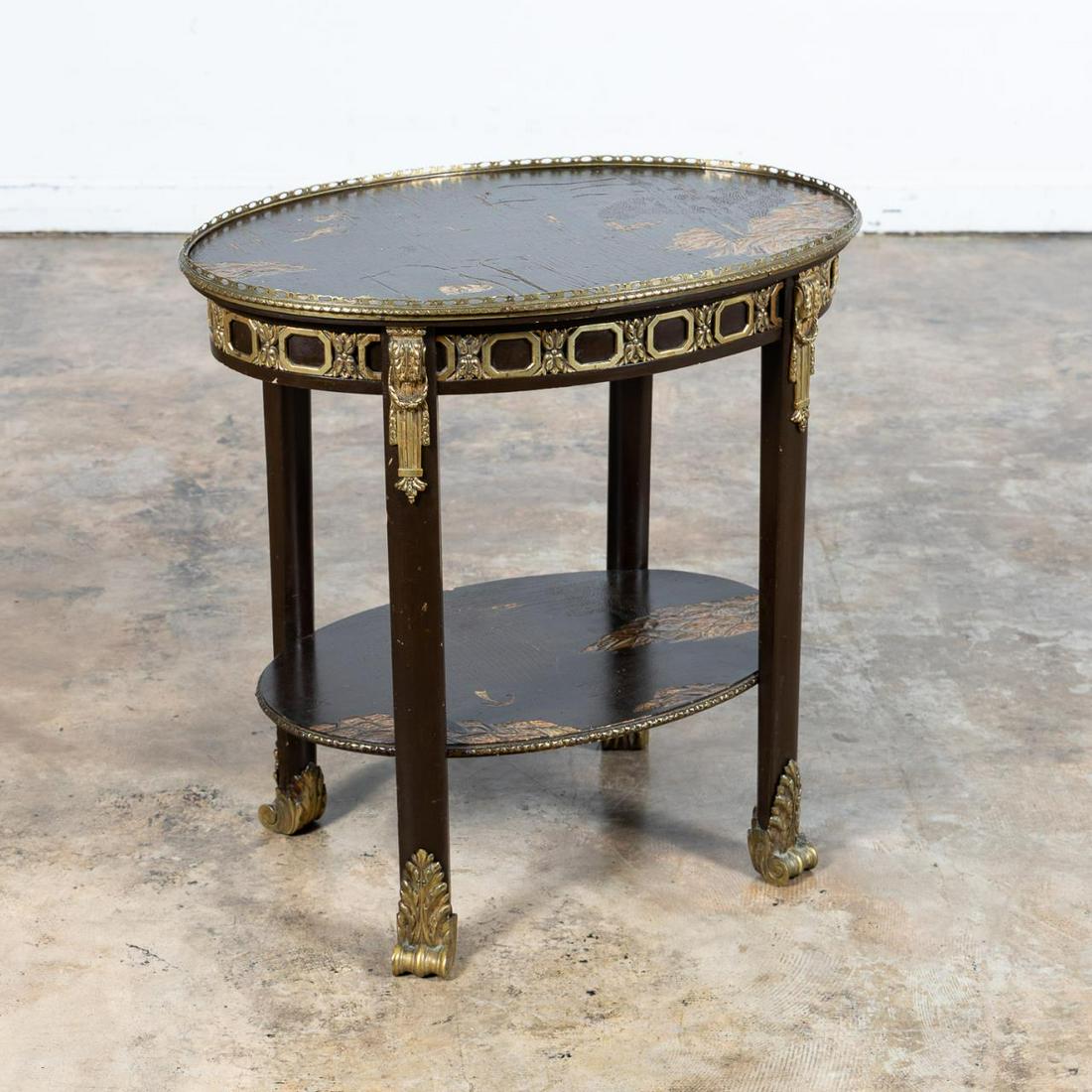 E. 20TH C. JAPANNED OVAL TABLE WITH ORMOLU MOUNTS: European, late 19th to early 20th century. Oval Japanned chinoiserie decorated side table in the Directoire taste, having ormolu mounts, candle slide decorated with figures in a landscape, and rising 