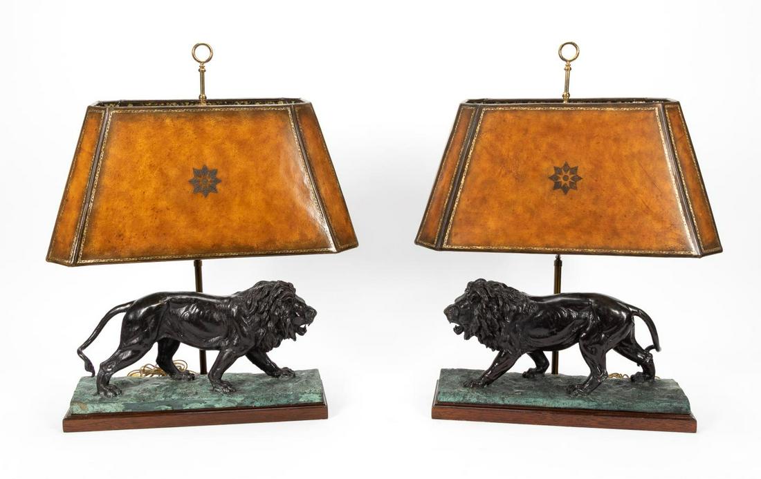 PAIR, MAITLAND SMITH BRONZE LION TABLE LAMPS: Maitland Smith, 20th century. Pair of patinated bronze single light table lamps having opposing striding lions, Sienna leather shades and mounted on dark wooden bases. Marked "MS" to the dial and with