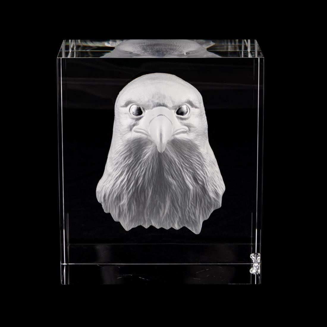 STEUBEN CRYSTAL MAJESTIC EAGLE HEAD SCULPTURE: Steuben Glass Works, 20th century. "Majestic Eagle" head sculpture, crystal block with a concave acid etched figure of a bald eagle. Etched "Steuben" to underside. Approx. h. 6.5", w. 5.75", d. 3.25".