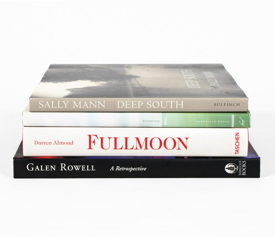 FOUR HARDCOVER ART BOOKS ON NOTABLE PHOTOGRAPHERS: Four hardcover coffee table books on famous photographers including "Darren Almond, Full Moon" published by Taschen, "Still, Oceanscapes by Debra Bloomfield", "Galen Rowell, A Retrospective" and "Deep