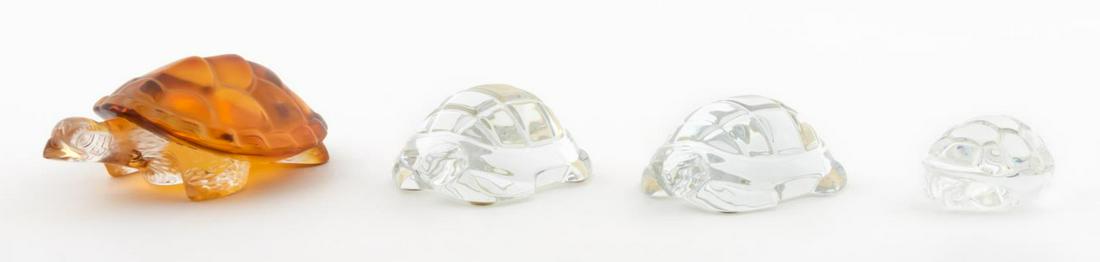 COLLECTION OF TURLES, LALIQUE, STEUBEN, BACCARAT: Collection of art glass turtles comprising amber Lalique, Steuben and two Baccarat. Each marked underneath.Longest approx. 6.75" (Lalique)
