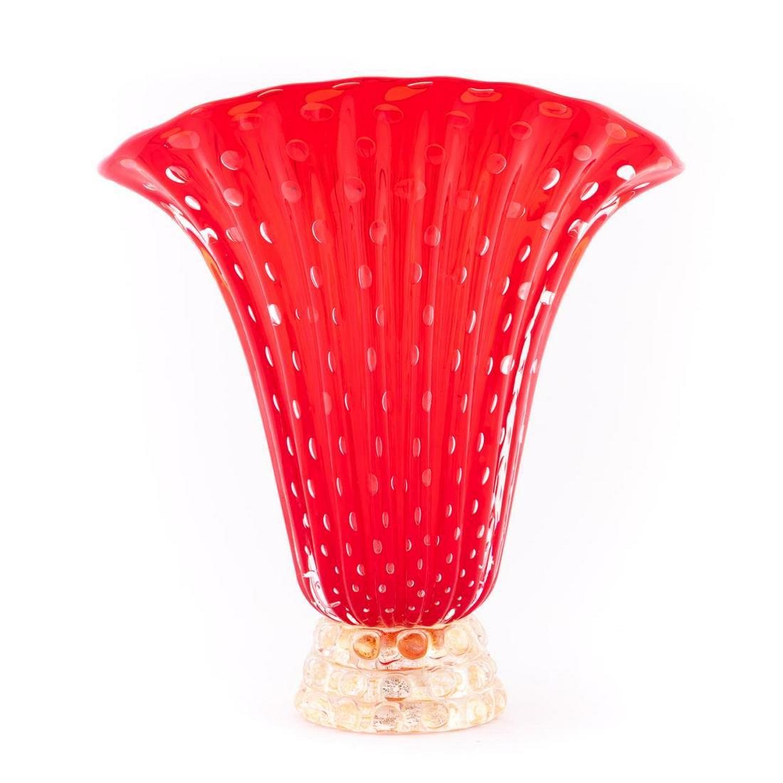 BAROVIER & TOSO, MURANO RED & GOLD ART GLASS VASE: Barovier & Toso, Italian, Mid-20th Century. A Murano art glass vase in brilliant red, the tall ovoid ribbed bowl with controlled air-bubbles supported on a clear and gold flecked bubble motif base. Ba