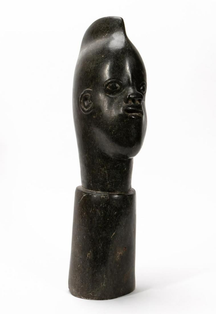 SHONA PORTRAIT SCULPTURE OF A MAN, CARVED STONE: Attributed to Ben Joosten (Zimbabwe, 20th c.). "Head of a Man", carved stone. Signed "June" underneath.Approx. h. 24" w. 6" d. 8.5"