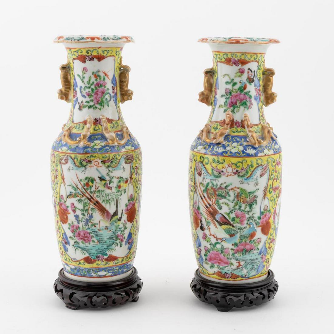 PAIR, CHINESE FAMILLE JAUNE PORCELAIN VASES: Chinese. A pair of porcelain famille jaune vases hand decorated with enamel painted birds, dragons and having floral and foliate windows. With wooden stands. Apparently unmarked. Approx: h. 10.25", w.