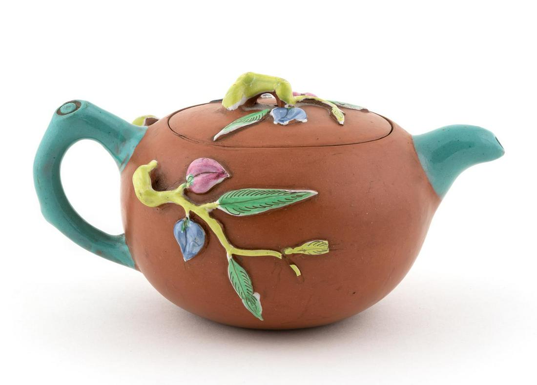 CHINESE YIXING ZISHA CLAY ENAMELED TEAPOT: Chinese. A yixing zisha clay teapot with enamel formed foliate branches to body and several bats to lid and body. Marked to underside of lid.Approx: h. 3.625", w. 5", d. 7".