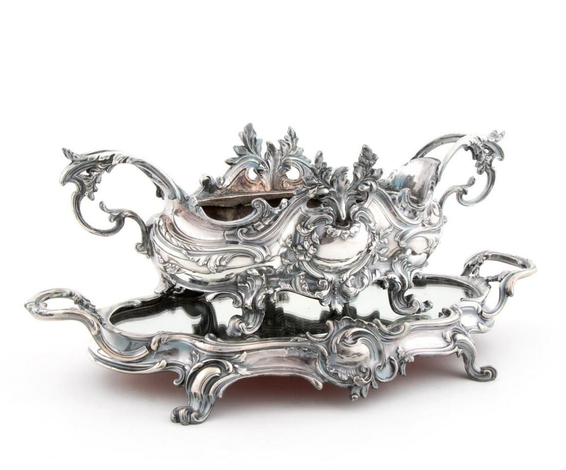 19TH C, FRENCH, SILVERPLATE JARDINERE AND PLATEAU: French, late 19th century. Rococo Revival silver plate jardiniere and plateau, oblong form with floral decoration, the conforming mirrored plateau on four scrolling feet. Apparently unmarked.Approx. h
