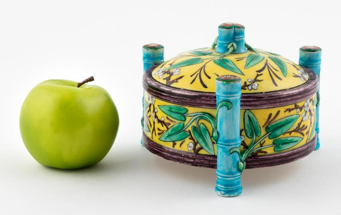 THEODORE DECK FAIENCE JAPANESQUE LIDDED JAR: Theodore Deck (French, 1823-1891), circa 1870. A French majolica lidded jar with bamboo form legs, yellow ground and foliate decoration to exterior. Marked to bottom "T.H. Deck".Approx: h. 5.25", w. 6