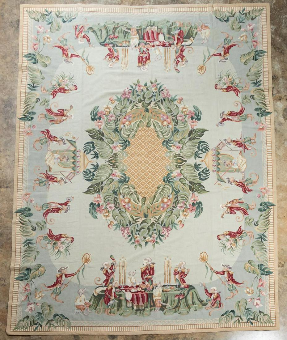 NEEDLEPOINT RUG, "MONKEY DINNER" - 9'8" X 13'10": Probably Chinese, circa 2000. Room size Aubusson style needlepoint rug featuring a foliage & pineapple center medallion, the border depicting a procession with a sedan chair riding female monkey with 