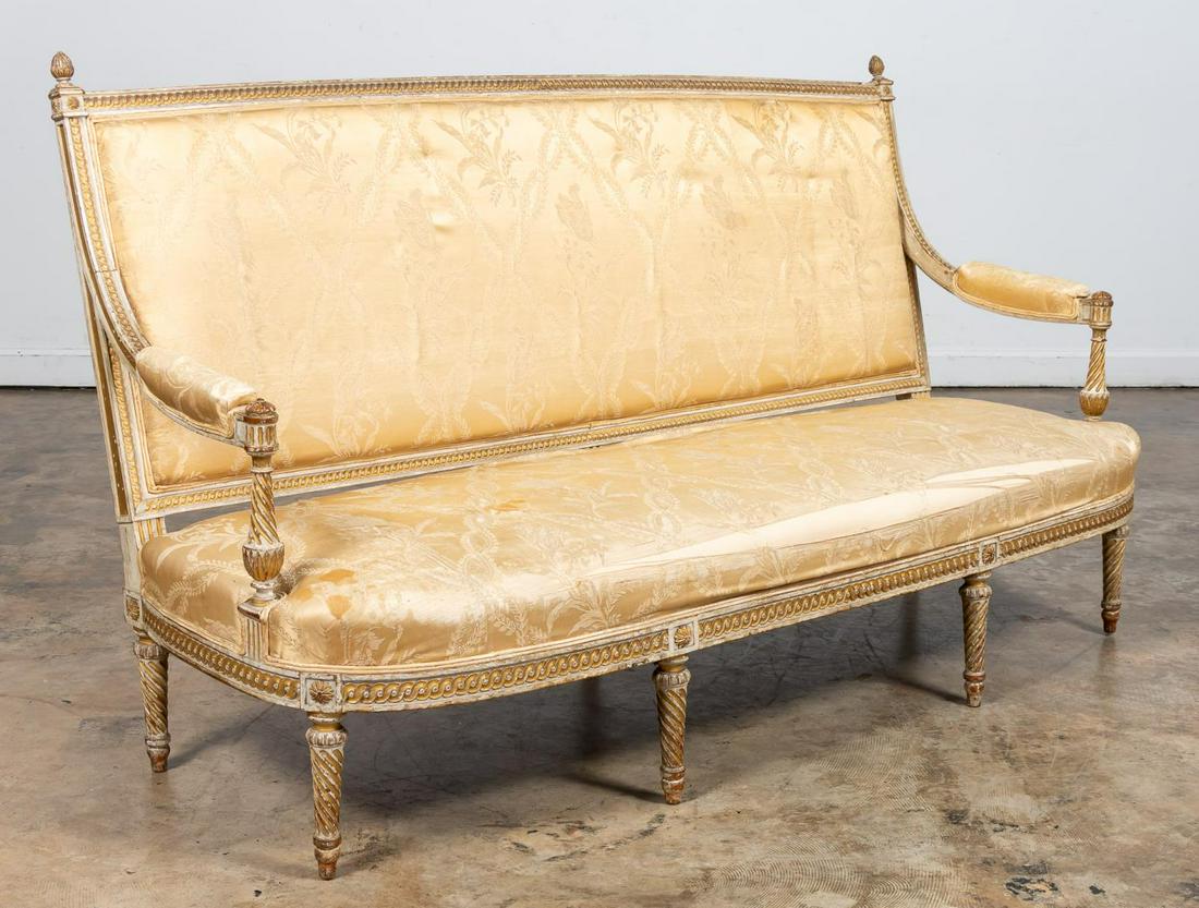 LOUIS XVI STYLE PAINTED & GILT FRAMED 7-LEG SOFA: French, Early 20th Century. Louis XVI style upholstered sofa with a painted and gilt finish carved wood frame, 7 spiral turned & tapered legs, spiral turned arm supports. Apparently unmarked.Approx. h