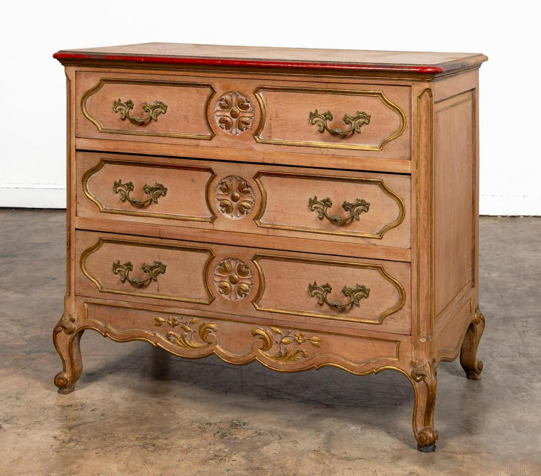FRENCH BEECHWOOD THREE DRAWER COMMODE: French, 20th century. Louis XV style three drawer commode with panel carved drawer fronts, paneled ends, floral carved skirt, gilt highlights to top edge, moldings and carvings, rising on scroll feet.