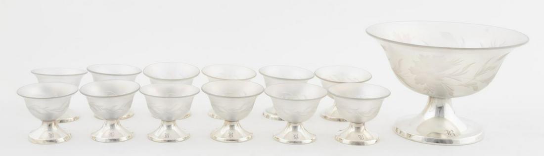 13 PC STEUBEN VERRE DE SOIE & STERLING DESSERT SET: Steuben, Hawkes and Gorham, circa 1916. A thirteen piece dessert service comprising of one sterling footed center bowl and twelve smaller sterling footed sherbet bowls; each having a hand engraved dec